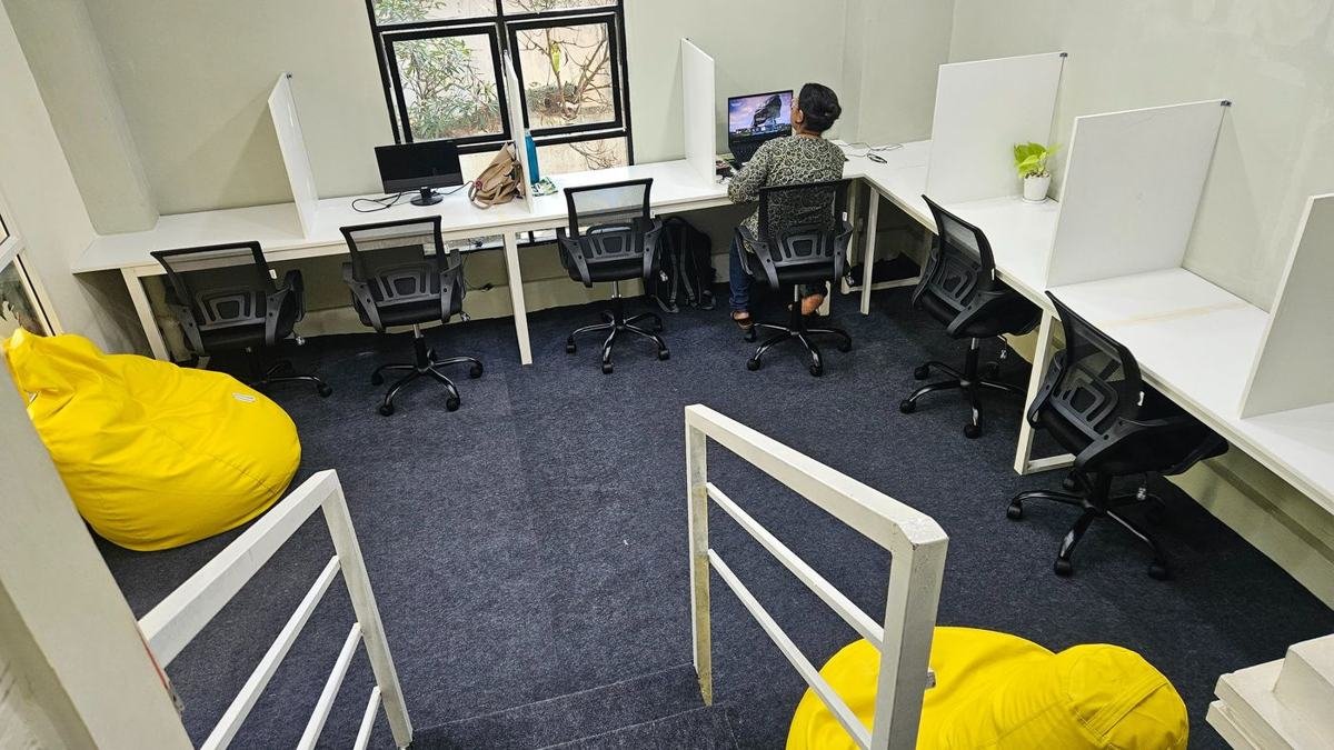 Workocafe study hall with partitioned desks, ergonomic chairs and yellow bean bags